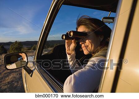 Hispanic woman looking through binoculars View Large Photo Image Stock Image - Hispanic woman looking through binoculars. Fotosearch