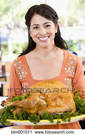 Hispanic woman serving Thanksgiving turkey View Large Photo Image Stock Image - Hispanic woman serving Thanksgiving turkey. Fotosearch