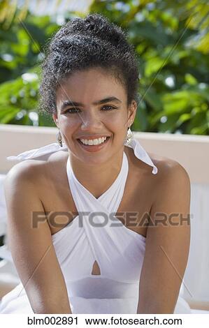 Hispanic woman sitting outdoors View Large Photo Image Stock Image - Hispanic woman sitting outdoors. Fotosearch
