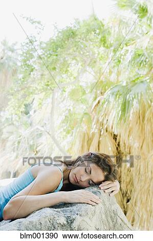 Hispanic woman sleeping on rock View Large Photo Image Stock Image - Hispanic woman sleeping on rock. Fotosearch