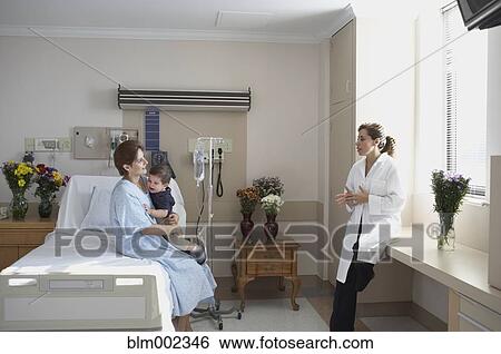 Stock Photograph - Hispanic woman talking to doctor. Fotosearch