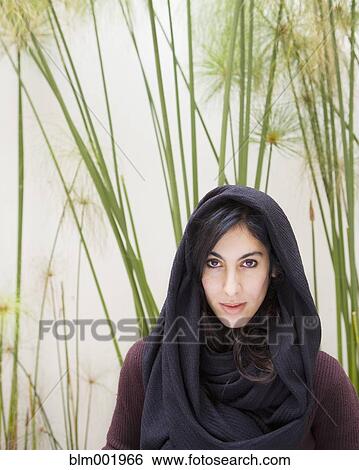 Stock Photograph - Hispanic woman wearing scarf over head. Fotosearch