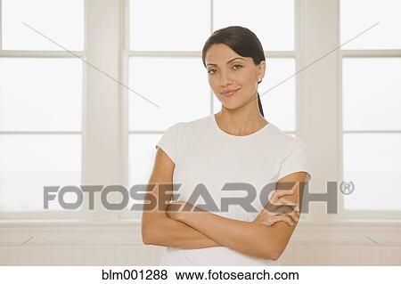 Stock Photo - Hispanic woman with arms crossed. Fotosearch