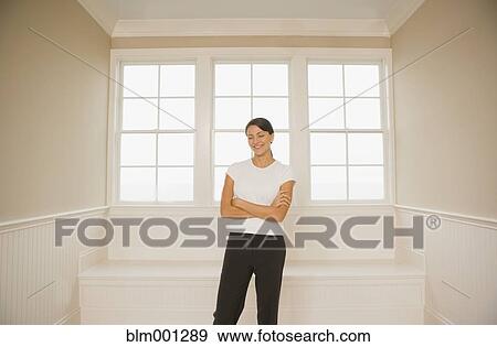 Stock Photo - Hispanic woman with arms crossed. Fotosearch