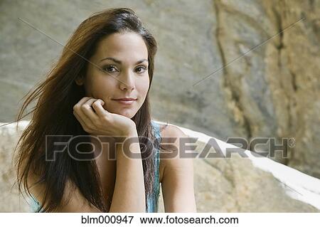 Stock Photo - Hispanic woman with head in hands. Fotosearch