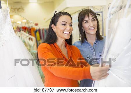 Stock Photo - Hispanic women shopping in bridal store. Fotosearch