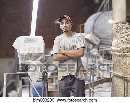 Stock Image - Hispanic worker in factory. Fotosearch