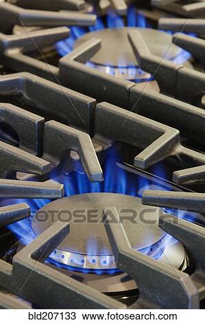 Stock Image - Ignited Gas Burning on Commercial Stove. Fotosearch