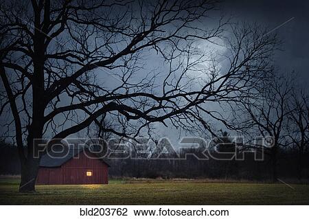Stock Image - Illuminated barn in rural landscape. Fotosearch