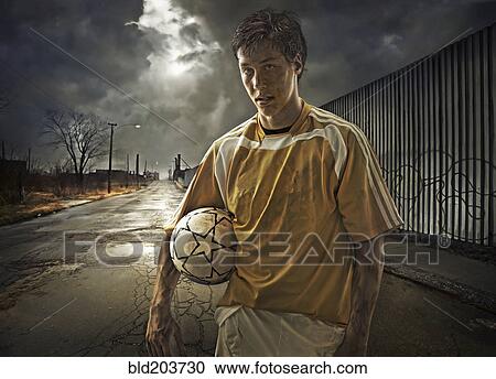 Stock Image - Illustration of soccer player holding ball on city street. Fotosearch