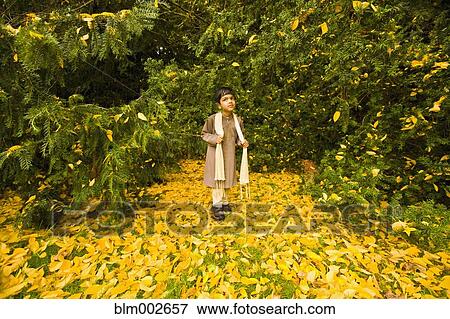 Stock Photo - Indian boy in front of trees. Fotosearch