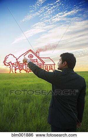 Stock Photograph - Indian businessman drawing house on sky. Fotosearch