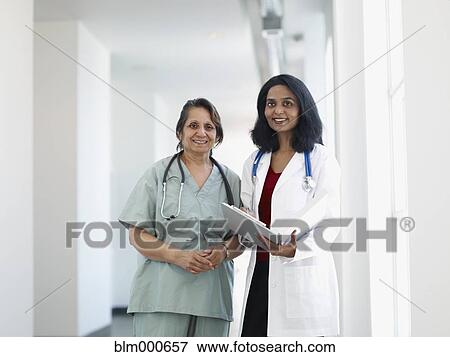 Indian doctor and surgeon talking in corridor View Large Photo Image Stock Photo - Indian doctor and surgeon talking in corridor. Fotosearch