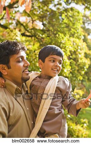 Indian father holding son View Large Photo Image Stock Photo - Indian father holding son. Fotosearch