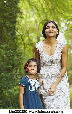 Stock Image - Indian mother holding daughterÆs hand. Fotosearch