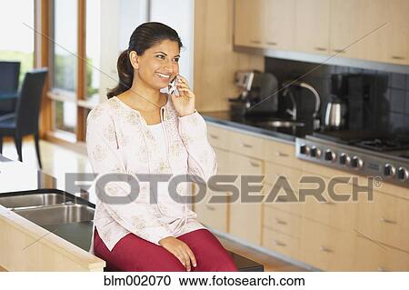 Stock Image - Indian woman talking on cell phone. Fotosearch