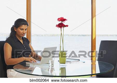 Indian woman typing on laptop View Large Photo Image Picture - Indian woman typing on laptop. Fotosearch
