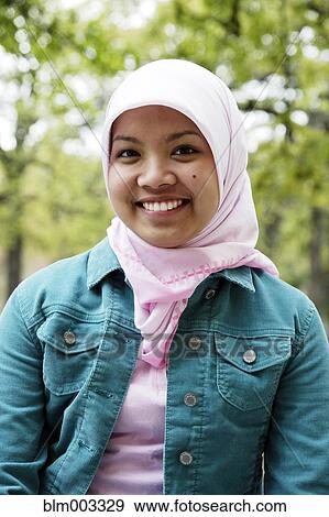 Stock Photo - Indonesian teenager wearing headscarf smiling. Fotosearch