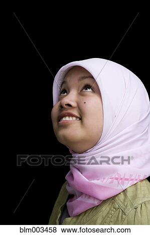 Stock Photo - Indonesian teenager wearing headscarf smiling. Fotosearch