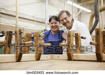 Stock Image - Instructor and student in workshop. Fotosearch