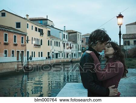 Picture - Italian couple kissing near canal. Fotosearch