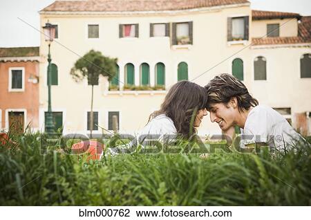 Italian couple laying in grass relaxing View Large Photo Image Stock Image - Italian couple laying in grass relaxing. Fotosearch