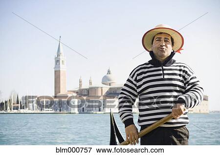 Stock Photo - Italian gondolier with church in background. Fotosearch