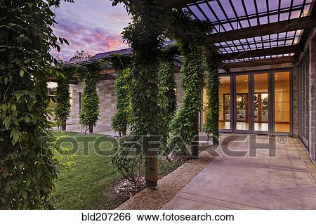 Stock Photograph - Ivy wrapped posts on patio. Fotosearch