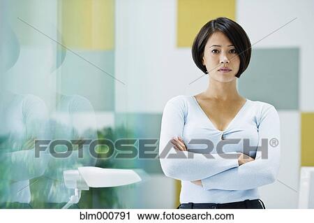 Stock Image - Japanese businesswoman posing in office. Fotosearch