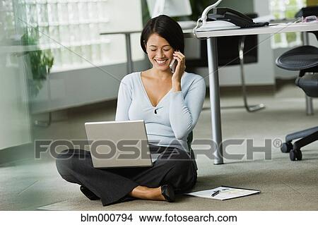 Picture - Japanese businesswoman working on office floor. Fotosearch