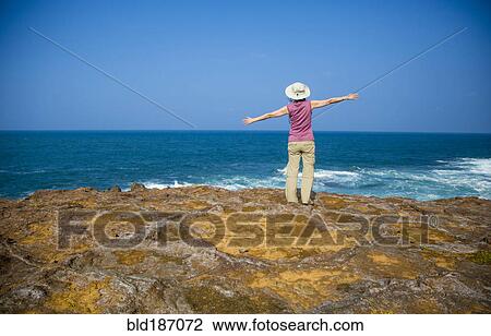 Japanese woman standing on rocky beach View Large Photo Image Stock Image - Japanese woman standing on rocky beach. Fotosearch