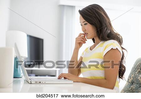 Stock Photo - Japanese woman using laptop. Fotosearch