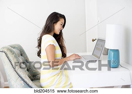 Japanese woman using laptop View Large Photo Image Stock Photography - Japanese woman using laptop. Fotosearch