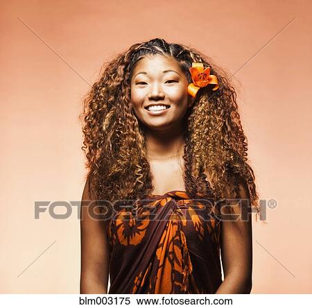 Stock Photography - Japanese woman with exotic flower in her hair. Fotosearch