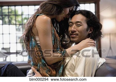 Korean couple being intimate on sofa View Large Photo Image Picture - Korean couple being intimate on sofa. Fotosearch
