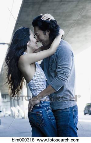Stock Photo - Korean couple kissing outdoors. Fotosearch