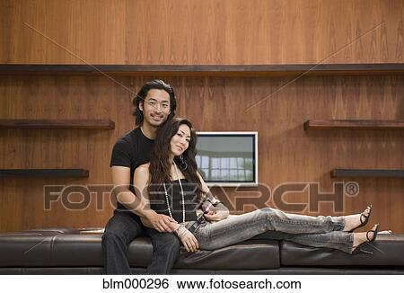 Stock Photograph - Korean couple on sofa. Fotosearch