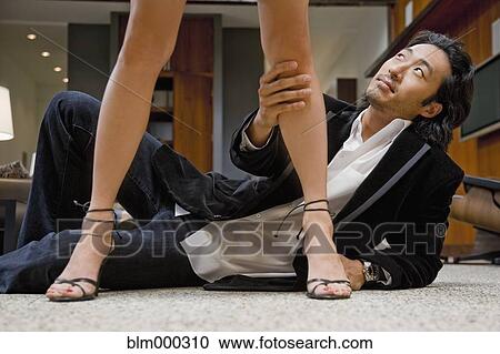 Korean man holding woman's leg and looking up View Large Photo Image Stock Image - Korean man holding woman's leg and looking up. Fotosearch