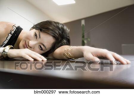 Korean woman leaning on table View Large Photo Image Stock Photo - Korean woman leaning on table. Fotosearch