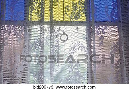 Stock Image - Lace Curtain and Stained Glass Window Panes. Fotosearch