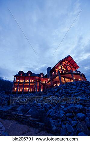 Stock Image - Large Wooden Hotel at Night. Fotosearch