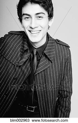 Laughing mixed race man in fashionable coat View Large Photo Image Stock Image - Laughing mixed race man in fashionable coat. Fotosearch