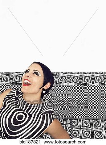 Stock Image - Laughing woman wearing retro patterned dress. Fotosearch