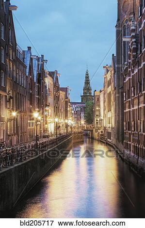 Stock Photo - Lit Canal Between Buildings. Fotosearch