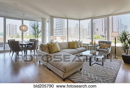 Stock Image - Living room and dining room in luxury highrise apartment. Fotosearch