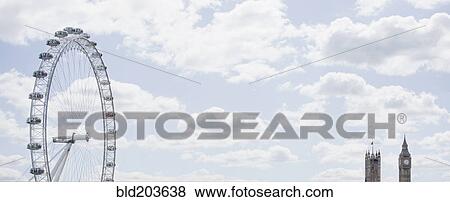 Stock Photo - London Eye and clock towers in blue sky, London, London, England. Fotosearch