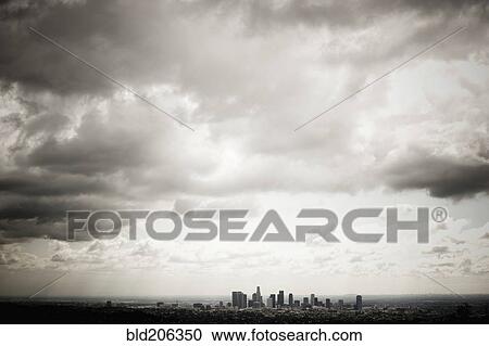 Stock Image - Los Angeles Skyline Beneath Cloudy Sky. Fotosearch