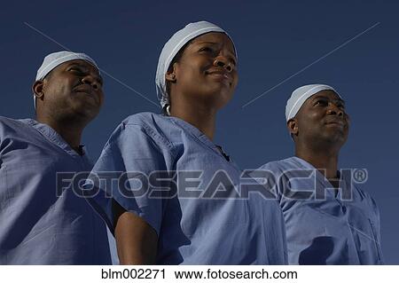 Stock Image - Low angle view of African American medical professionals. Fotosearch