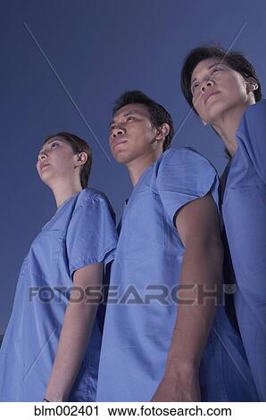 Stock Image - Low angle view of Asian medical professionals. Fotosearch