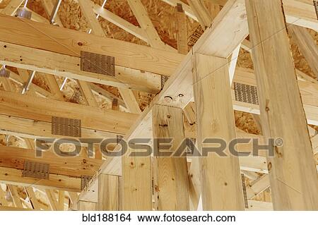 Picture - Low angle view of ceiling beams in new house. Fotosearch